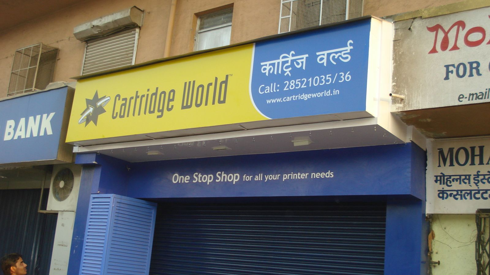 Finished Cartridge World retail storefront with yellow and blue signboard