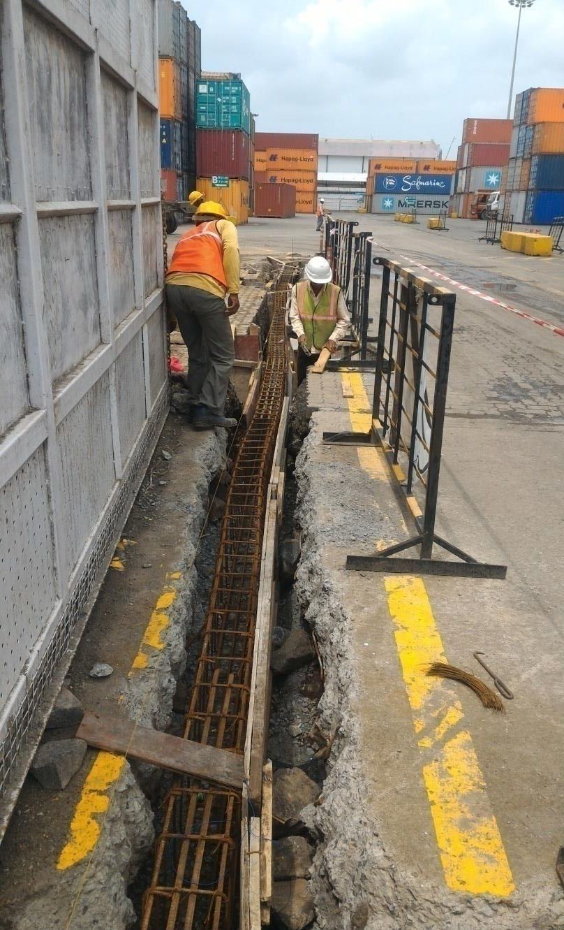 Reinforced concrete foundation and blockwork in progress at a container terminal