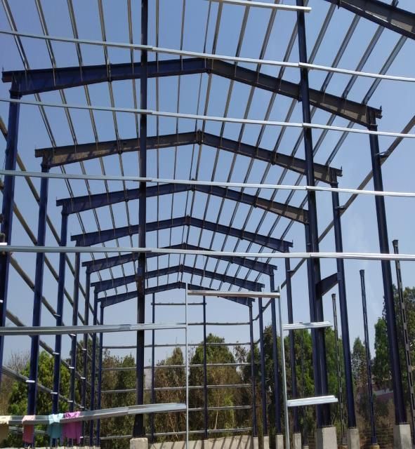Pre-engineered steel building frame under erection