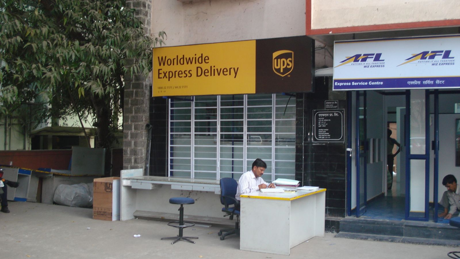 Finished express-delivery service centre front office with signboards in Pune